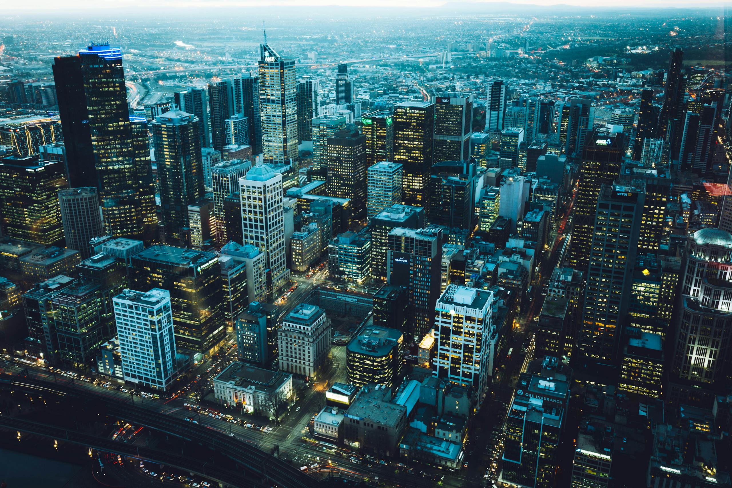 Captivating aerial view of a bustling city skyline at night with illuminated skyscrapers.